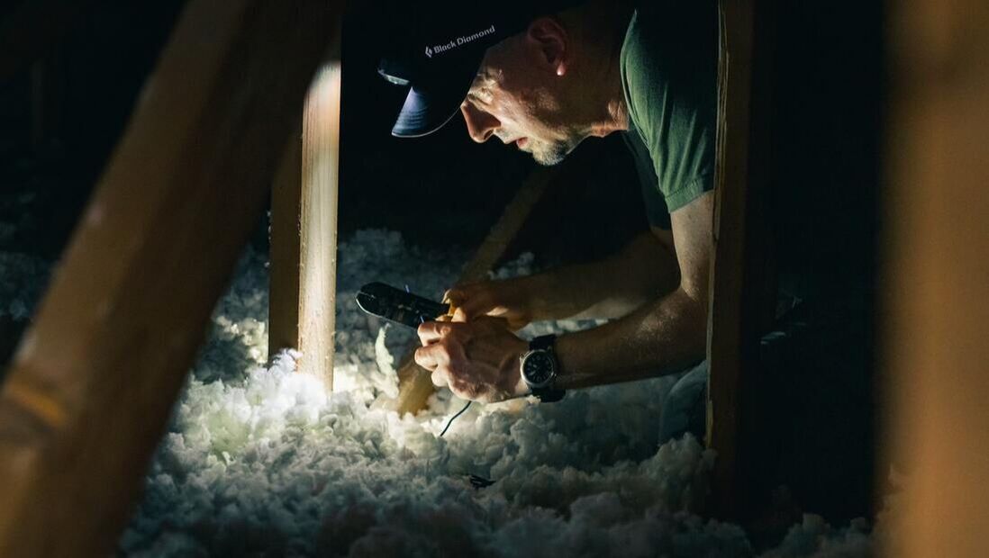 contractor inspecting attic insulation in Glenview home